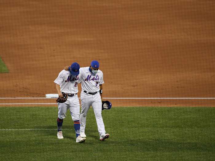Dominic Smith walks off the field with a teammate